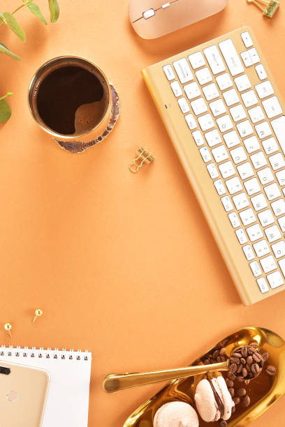 istock Flat lay. View from above. Business concept with a golden computer keyboard, macarons, a cup of coffee. Place for text. 1139847463