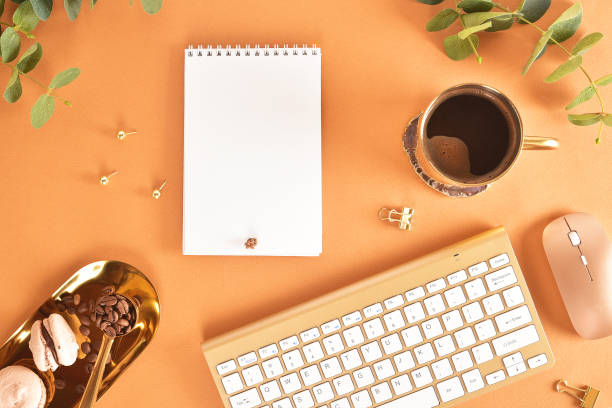 Flat lay. View from above. Business concept with a golden computer keyboard, macarons, a cup of coffee. Place for text.