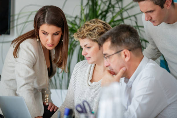 istock Coworkers looking at content on laptop seriously 1139847620