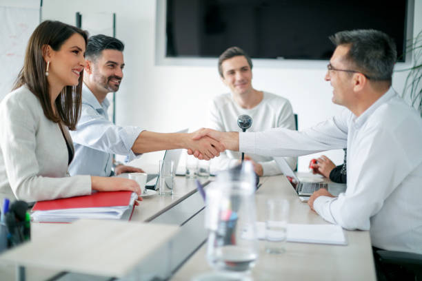 istock Shaking hands with new business partners in board room 1139847627