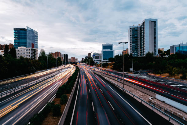 istock Motorway with light trails at dusk against cityscape 1139847834