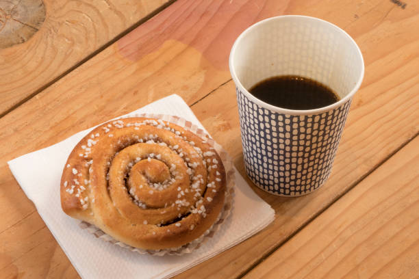 Stockholm, Sweden Stockholm, Sweden Kaffe med bulle. A coffee with a cinamon bun. black coffee swirl stock pictures, royalty-free photos & images