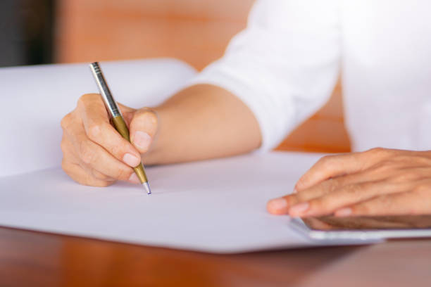 istock Selective focus of Casual young business man hand using mobile smart phone with pen blurred background 1139849131