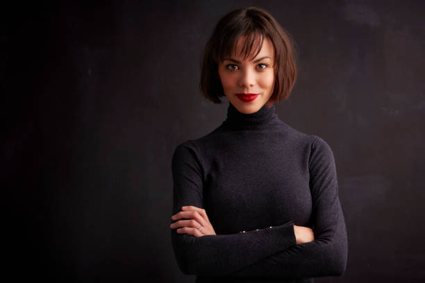 istock Attractive woman studio portrait while looking at camera and smiling 1139850002