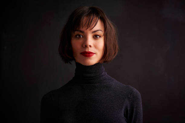 istock Attractive woman studio portrait while looking at camera and smiling 1139850006