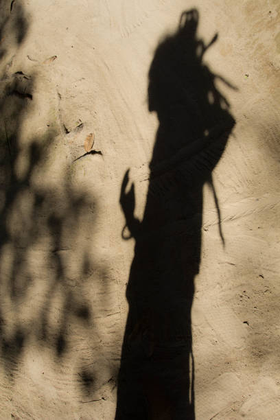istock Shadows of people in various stance on soil background. 1139850768