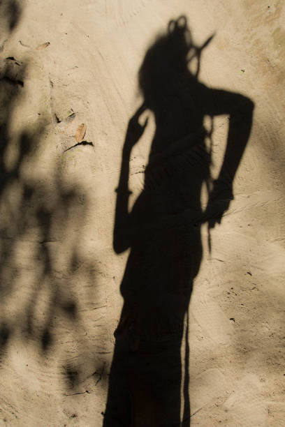 istock Shadows of people in various stance on soil background. 1139850788