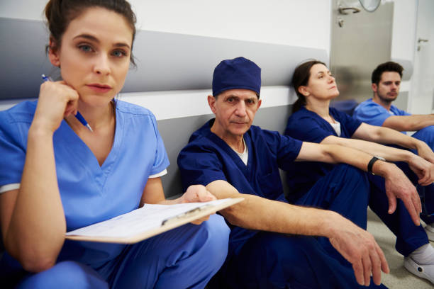 istock Group of tired surgeons after long day at work 1139851221