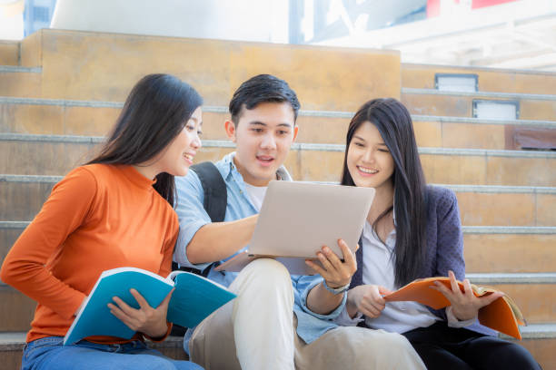 istock Close up of Happy high school students group are in attending of tutorial with notebook on the stair, education concept. 1139851251