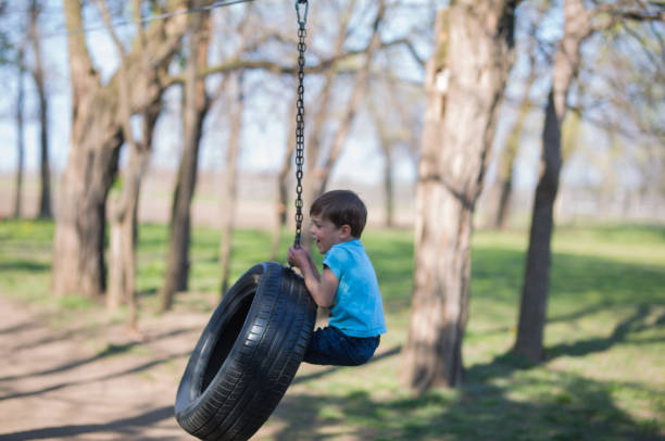 istock Little boy swinging on an improvised swing 1139851342