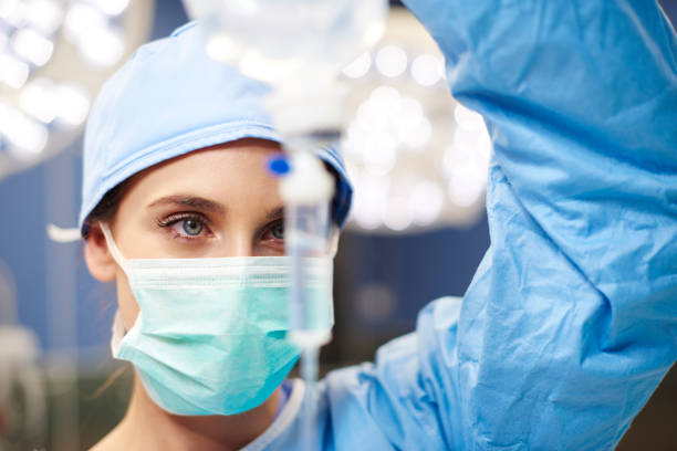 Female anesthesiologist during hard operation stock photo