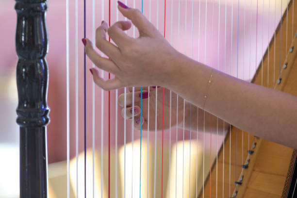 istock female fingers playing the harp 1139854044