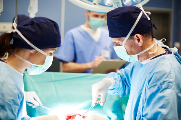 Busy surgeons over the operating table stock photo