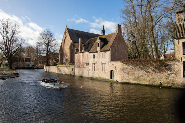 Bruges, Belgium: Classic sights at Bruges canal and tourboat in Belgium.