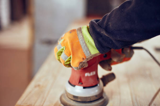 istock Male carpenter using orbital electric sander in a retro vintage workshop. 1139856973