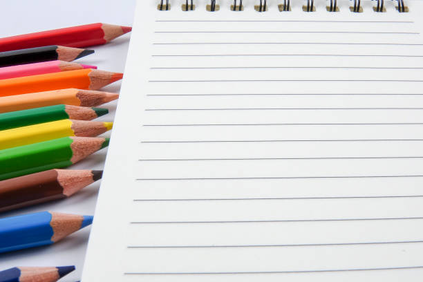 istock Close-Up Of Colored Pencils With Blank Note Pad On Table 1139857358