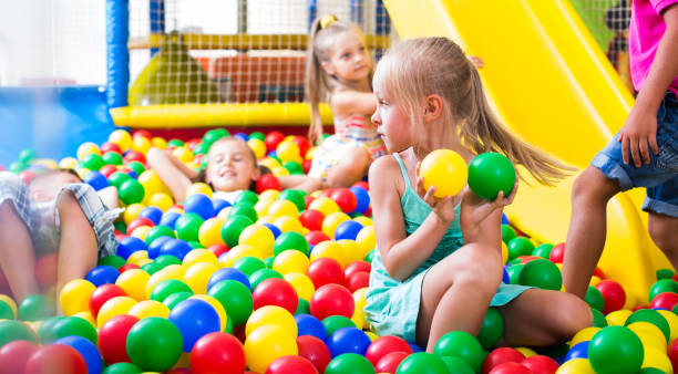 istock girl playing with multicolored plastic balls 1139857752