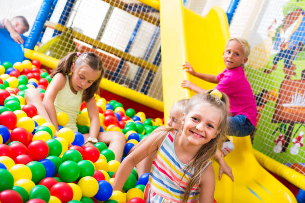 istock girl playing with multicolored plastic balls 1139857756