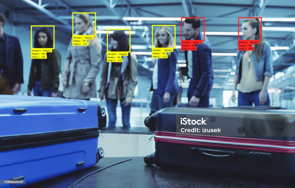 Facial Recognition Technology at the Airport Facial Recognition System at the Airport. People waiting for luggage. Facial Recognition Technology Stock Photo