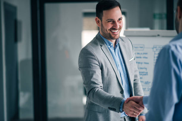 istock Handsome manager handshake with a colleague. 1139862045