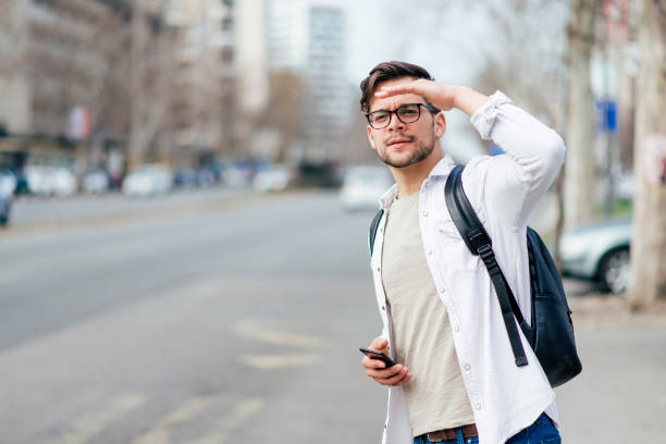 istock Casual young man looking for a taxi. 1139864555