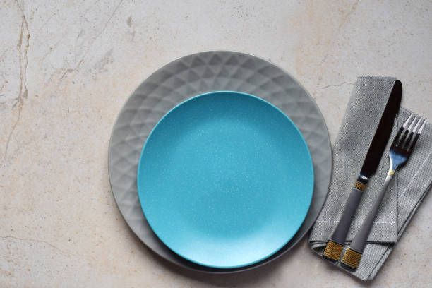 istock Multicolored empty ceramic plates and bowls on a marble background. Table setting. Shabby chic or retro style. Copy space. Mock up, concept for restaurant, menu 1139864716