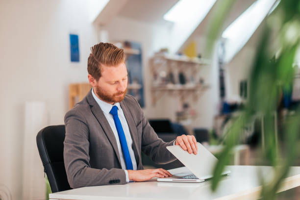 istock Office worker starting work on laptop at modern office. 1139864774