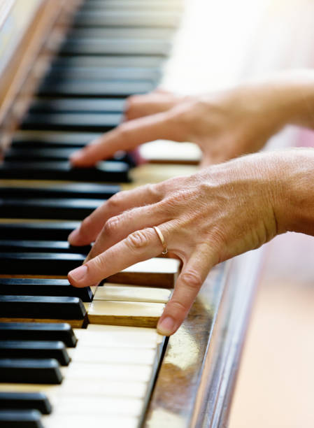 istock Female hands playing an antique piano 1139865107