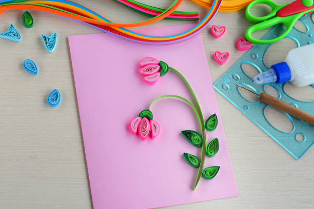 istock Quilling technique. Making decorations or greeting card. Paper strips, flower, scissors. Handmade crafts on holiday: Birthday, Mother's or Father's Day, March 8, Wedding. Children's DIY concept. 1139866543