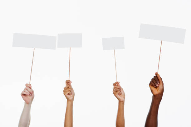 istock Four mixed hands hold blank signs ready for your message 1139867051