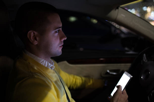 istock Man in his car texting at the parking lot 1139867189