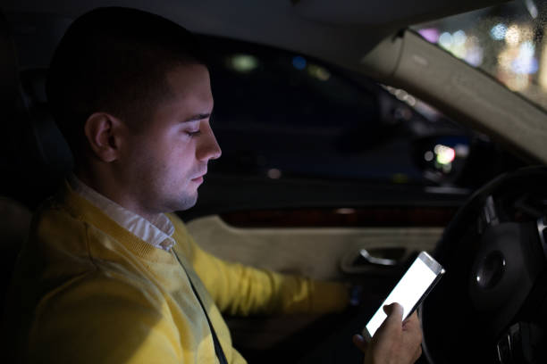 istock Man in his car texting at the parking lot 1139867217