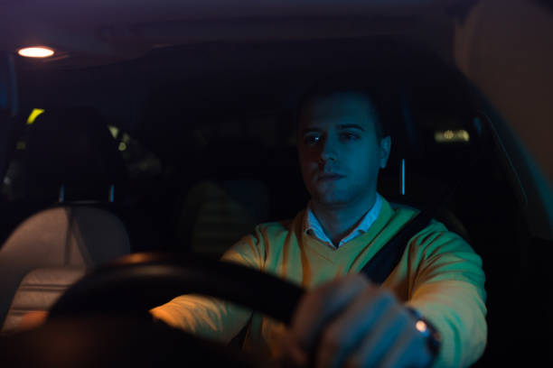 istock Tired man is driving a car at night 1139867757