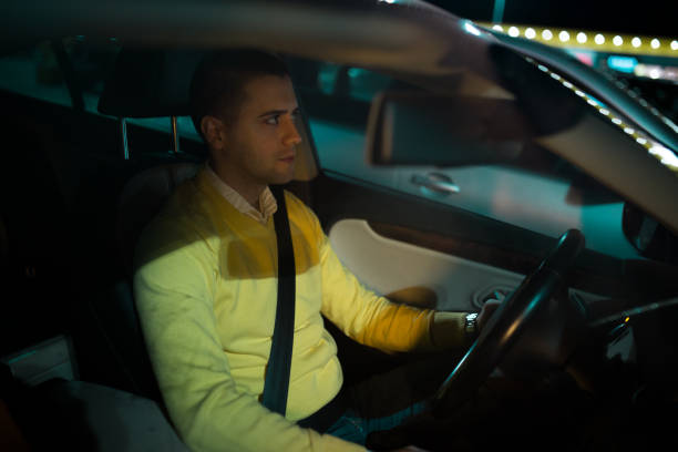 istock Young man in the car looking who is behind his car 1139867863