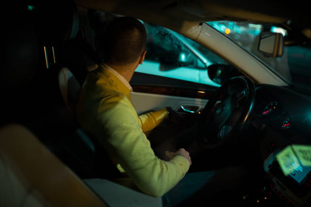 istock Young man in the car looking who is behind his car 1139867914