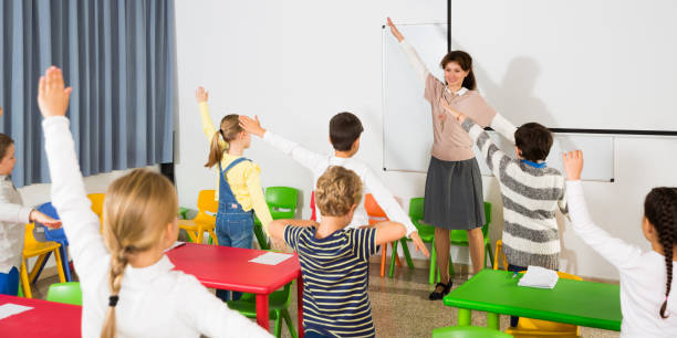 istock Teacher conducting warm-up with pupils 1139868261