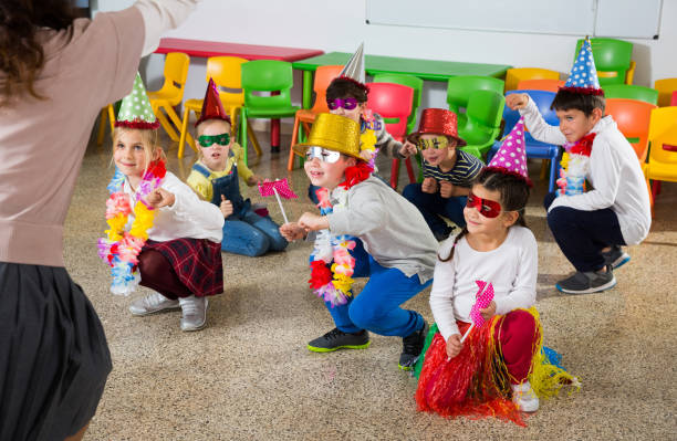 istock School kids with teacher in festive hats having fun 1139868274