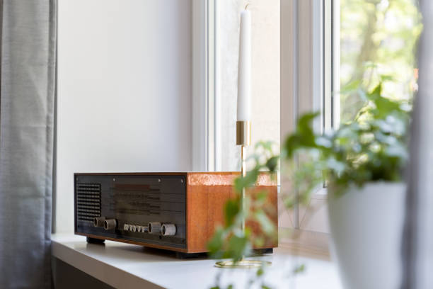 Home interior with vintage radio standing beside window