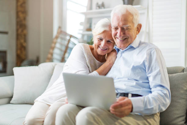 istock Senior couple using laptop computer at home 1139871999