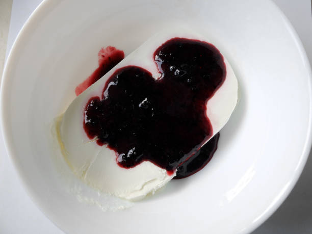 istock Plate of white ice cream drenched jam. 1139872112