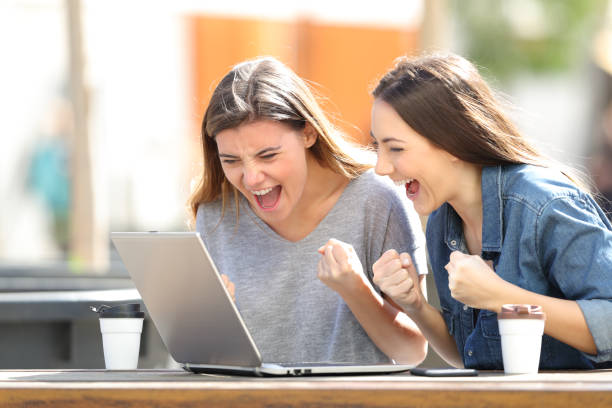 istock Excited women checking laptop content in a park 1139872169