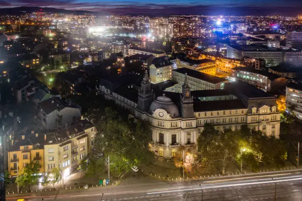 Panoramic high angle view above Western city of Sofia, Bulgaria, Eastern Europe during twilight with the illuminated buildings and downtown evening lights. Shot on Canon EOS full frame system with tilt-shift prime lens.