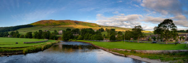 River Wharfe In The Yorkshire Dales Looking down the River Wharfe from Burnsall Bridge, deep in the Yorkshire Dales. river wharfe stock pictures, royalty-free photos & images