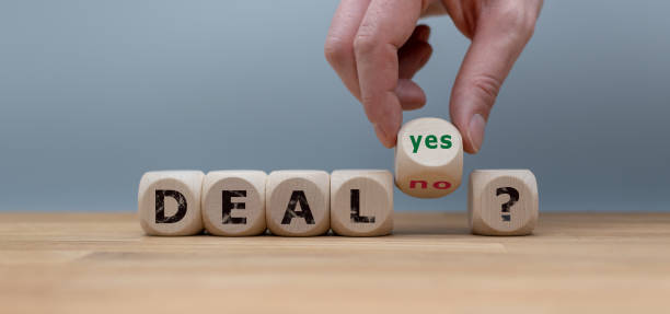 Deal or no deal? Hand turns a cube and changes the word "no" to "yes". stock photo
