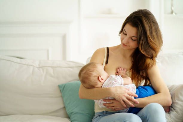 young mother breastfeeding her little son