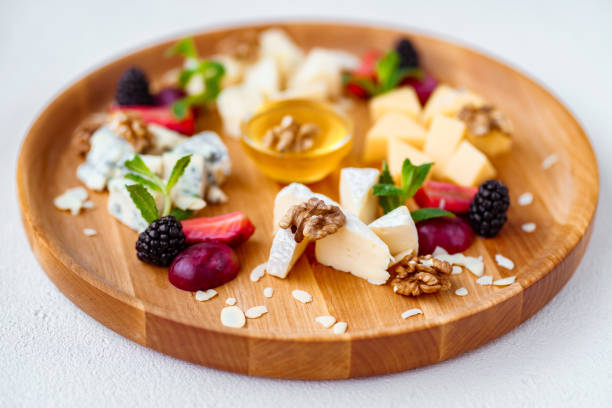 istock Assortment of different cheeses on wooden platter 1139872846