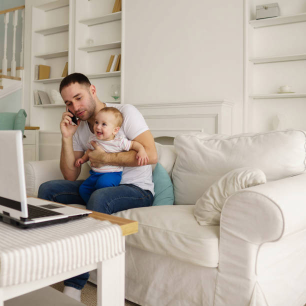 istock father working, talking on phone and babysitting 1139873458