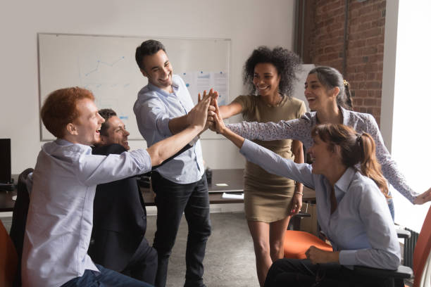 istock Happy diverse office employees group give high-five, corporate trust concept 1139873742
