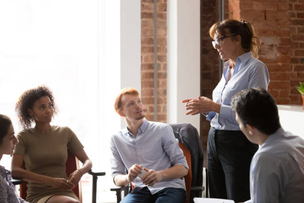 istock Serious coach leader speaking teaching diverse staff at group meeting 1139873747