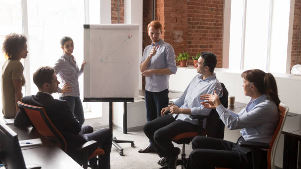 istock Confident male business coach speaker giving corporate flip chart presentation 1139873749